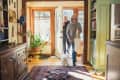 Man and woman arriving home with shopping