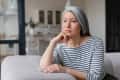 Sad depressed tired lonely divorced ill mother mature woman feeling unwell, unhealthy, suffering from midlife crisis on lockdown, social distance