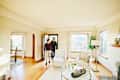 Couple walking into living room of home for sale during open house