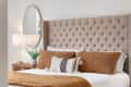 bedroom detail with a brown headboard and bedding