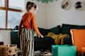 A little girl in a untidy playroom