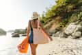 Young woman going to the beach alone