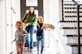 Young girls bringing delivery package into home -
