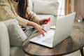 Woman hands using credit card and laptop for online shopping