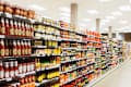 Stocked shelves in grocery store aisle