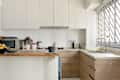 Home kitchen with white cabinets and an island