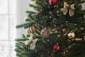 Christmas tree with gold fabric bows and other ornaments