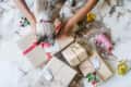 Cat checking out a pile of wrapped gifts. overhead photo