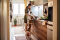 Woman cooking in the kitchen with her dog