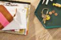 Closeup of 2 "catch-all" trays (for keys, etc) and a pile of mail on a wood table.