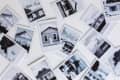 Scattered black and white Polaroid photos of various houses with different architectural styles.