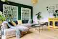 Modern and cozy living room with corduroy sofa, coffee table, plants and big window to the garden. Bright and sunny family space.