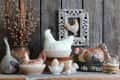 Collection of Vintage Porcelain, Faience, Ceramic Chicken Butter-Dish, Egg cup, Figurine, Branches of Willow in Old Authentic Clay Pot, Weathered Rectangular Frame on Wooden Background , Easter scene