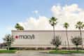 Vero Beach, Florida; USA;  June 23, 2019. Macy's  store logo is pictured on the outside of the store  a long with tall palm trees on a sunny day in Florida. Front view.