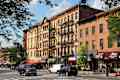: People walk in Prospect Heights, Brooklyn. New York City is visited by 56 million annual visitors (2014). 20 million people live in NY metropolitan area.