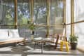 A mid century modern screened in porch
