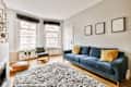 Interior design of modern minimalist style living room with large windows and wooden couch and cabinet and TV placed on white wall