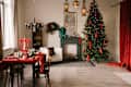 Beautiful New Year decor, the Christmas tree is decorated with red bows in the stylish interior of the living room