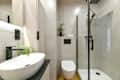 Photo of modern small bathroom with cashmere cabinets, LED-lit mirror, wall-hung toilet and shf modern small bathroom with cashmere cabinets, LED-lit mirror, wall-hung toilet and shower cubicle