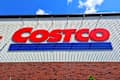 Raleigh, North Carolina - May 2 2025: Costco Wholesale Gold Star Membership Card Held In Hand in Front of Storefront Location