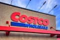 Calgary, Alberta, Canada. March 8, 2026. Exterior of a Costco Wholesale warehouse building featuring the large red and blue brand logo against a blue sky.