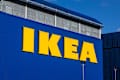 The iconic yellow Ikea logo is displayed prominently on the blue exterior of a large retail warehouse store against a clear sky. London, UK, 17 March 2024