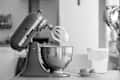Stand mixer next to eggs and flour.