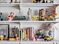 wall covered in shelves for books and art objects