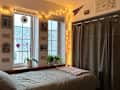 Lights strung across white wall in dorm
