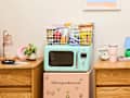 microwave on top of a fridge in dorm room