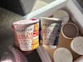 Someone holding pints of Bridgerton themed Jeni's Ice cream.