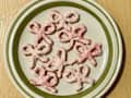 Chocolate pretzel bows with pink dye and sugar.