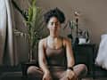 Zen, relax and mediation with black woman and yoga in bedroom for calm, peace and morning routine. Wellness, breathing and balance with health girl training at home for spiritual, healing and energy
