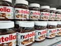 Surabaya, Indonesia 04-08-2024 : Side shot of Nutella spread product. Line or row of NUTELLA Ferrero Hazelnut Spread With Cocoa for sale in the supermarket with selective focus.
