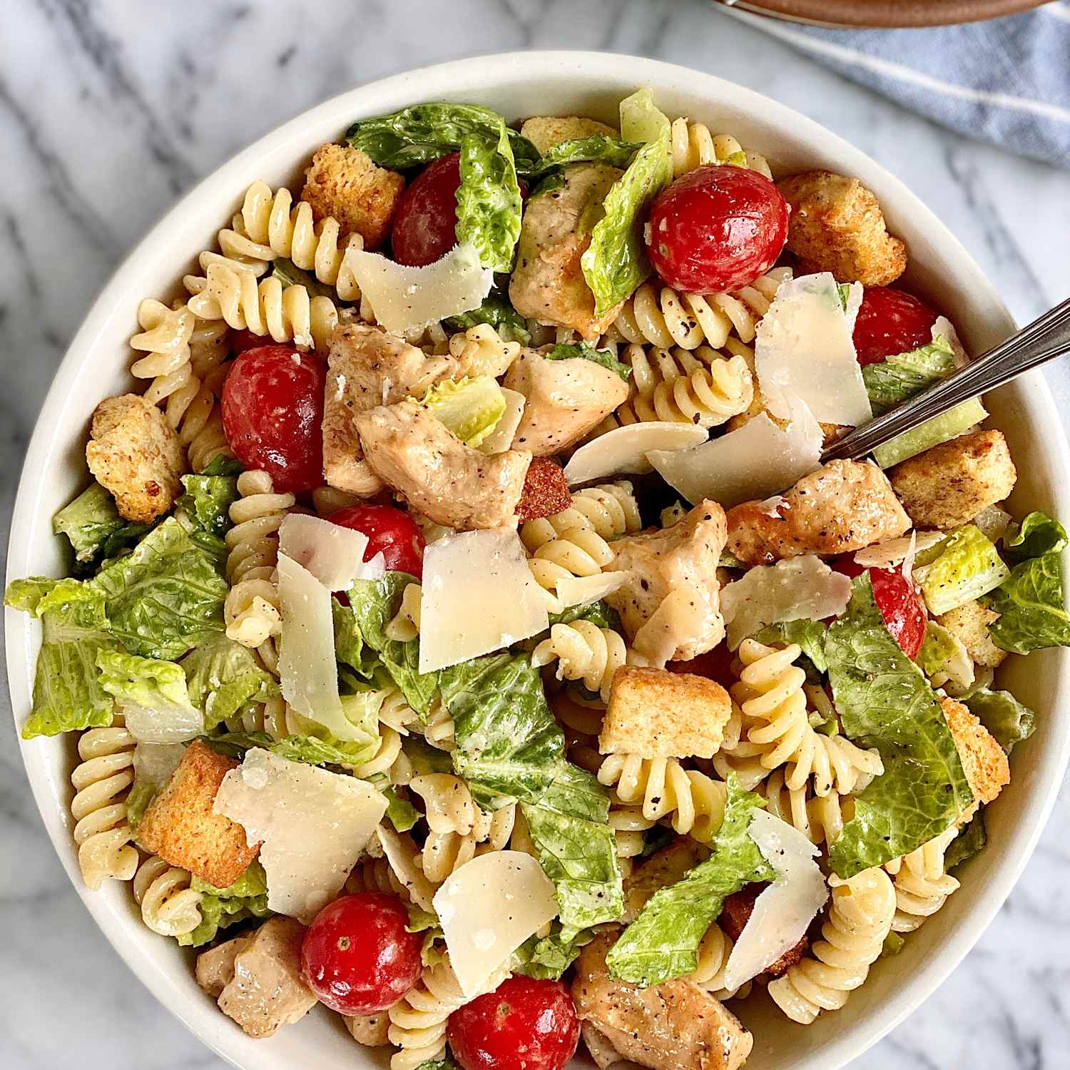 https://cdn.apartmenttherapy.info/image/upload/f_jpg%2Cq_auto%3Aeco%2Cc_fill%2Cg_auto%2Cw_1500%2Car_1%3A1/k%2FEdit%2F07-2022-caesar-pasta-salad%2Fcaesar-pasta-salad2