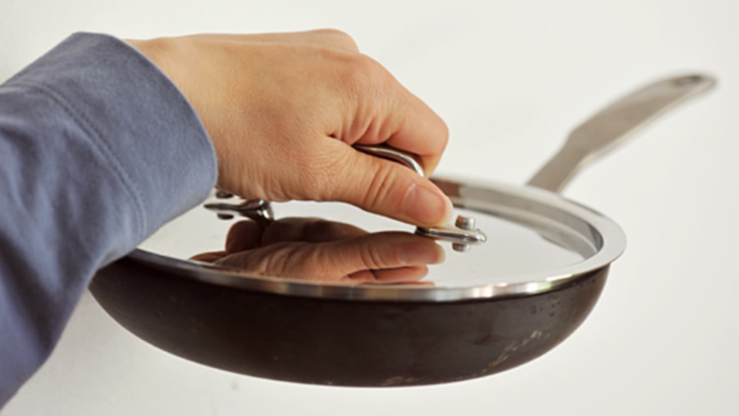 What is the benefit of putting a lid on top of a pan when cooking
