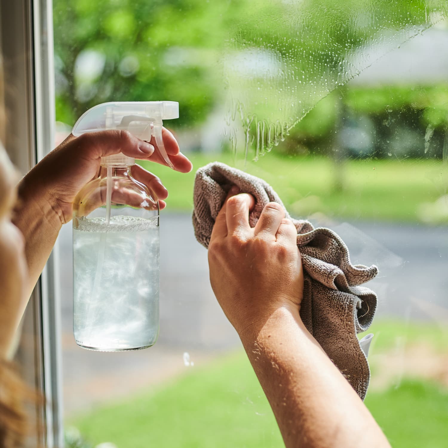 Bucket Spray And Squeegee For Window Cleaning On The Window Sill