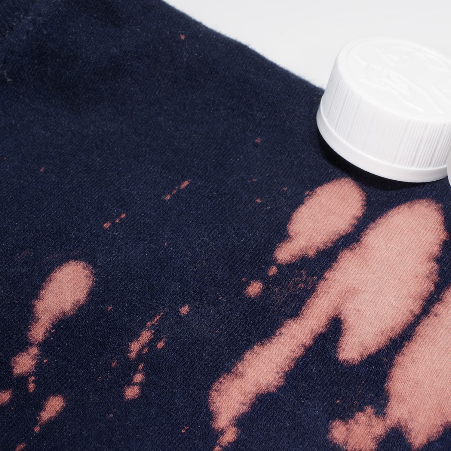 What is the best way to get rid of small bleach stains on black