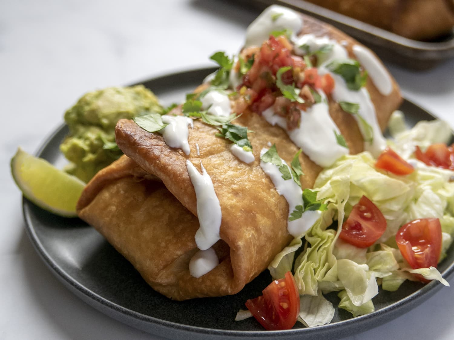 Queso-Smothered Beef Chimichangas - The Chunky Chef