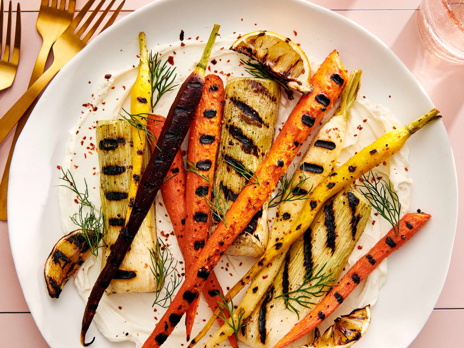 https://cdn.apartmenttherapy.info/image/upload/f_jpg,q_auto:eco,c_fill,g_auto,w_1500,ar_4:3/k%2FPhoto%2FRecipes%2F2022-08-grilled-carrots-and-leeks-with-labneh%2Fk-grilled-carrots-and-leeks-with-labneh