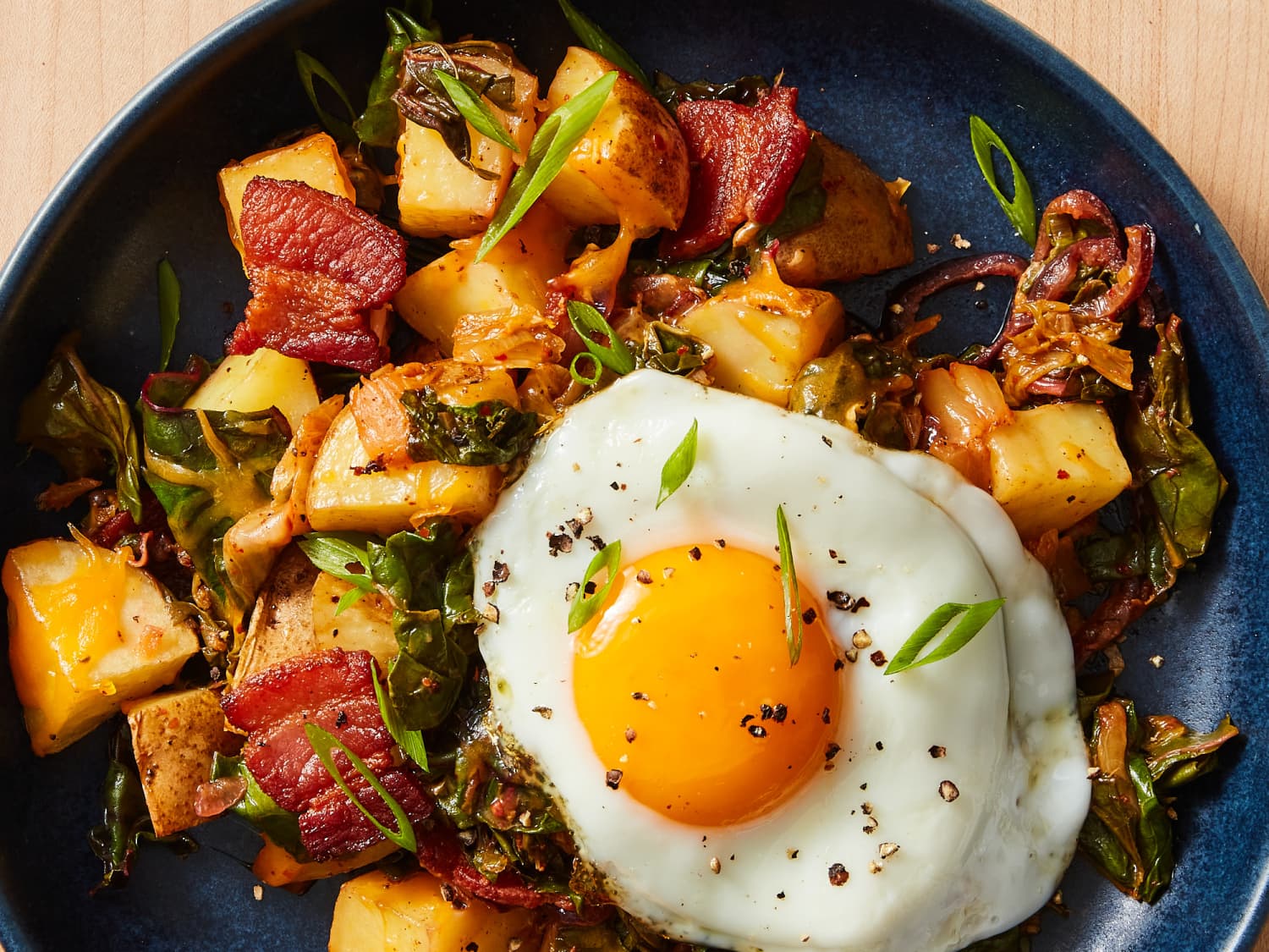 https://cdn.apartmenttherapy.info/image/upload/f_jpg,q_auto:eco,c_fill,g_auto,w_1500,ar_4:3/k%2FPhoto%2FRecipes%2F2022-11-cheesy-kimchi-breakfast-skillet%2Fcheesy-kimchi-breakfast-skillet-0272