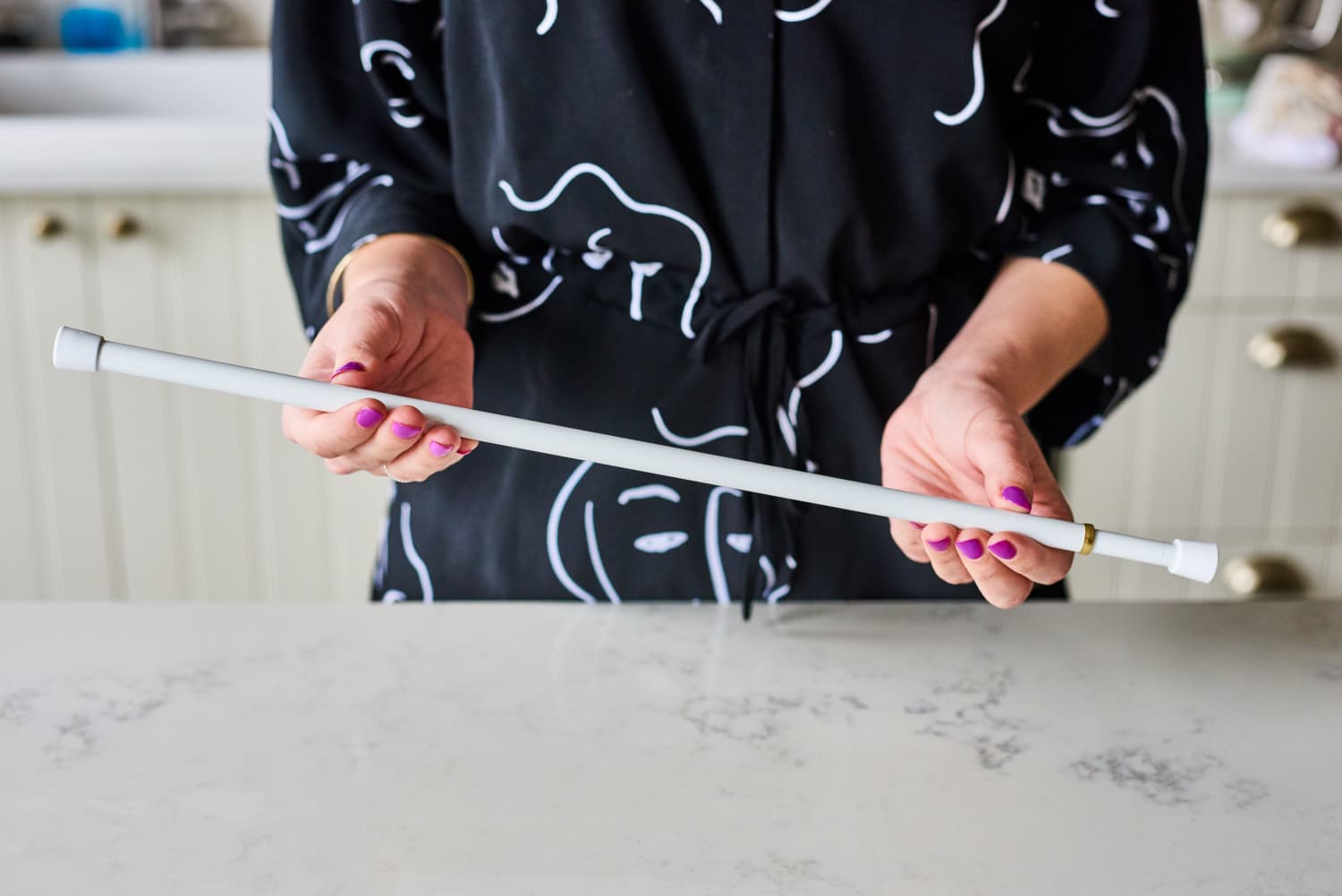 One Unexpected (and Super Smart) Place to Add a Tension Rod In Your Kitchen