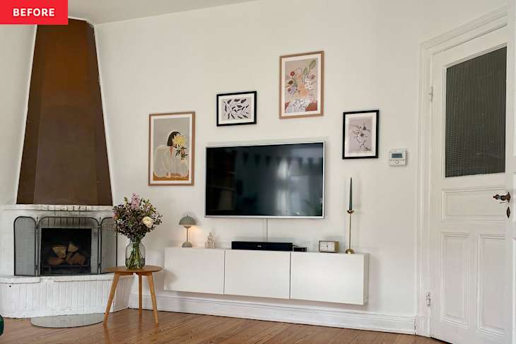 white living room with hanging art, a TV and fireplace