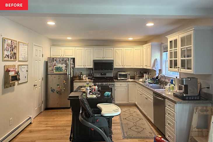 Kitchen with white cabinets and many items on countertops