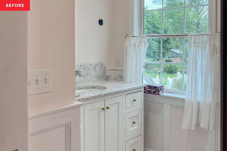 White bathroom vanity with marble top before renovation.
