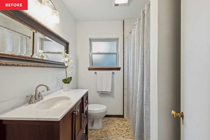 Modern bathroom featuring a wooden vanity with a marble countertop, a large mirror, a white toilet, and a shower curtain.