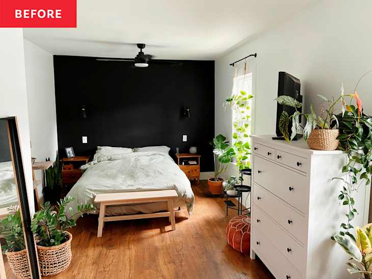 A white bedroom with a black accent wall