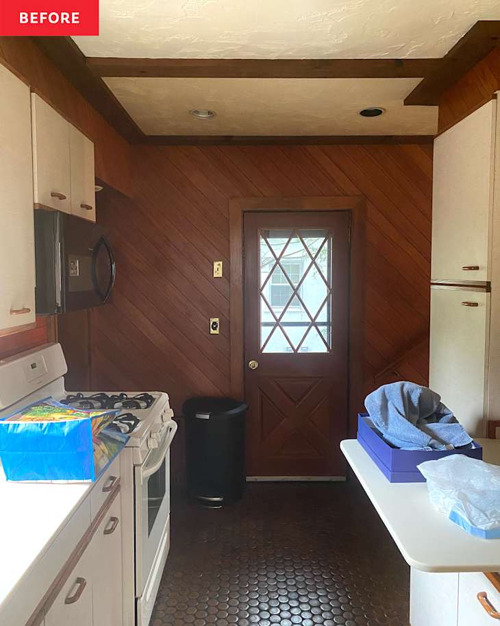 Wood paneled wall in kitchen before renovation.