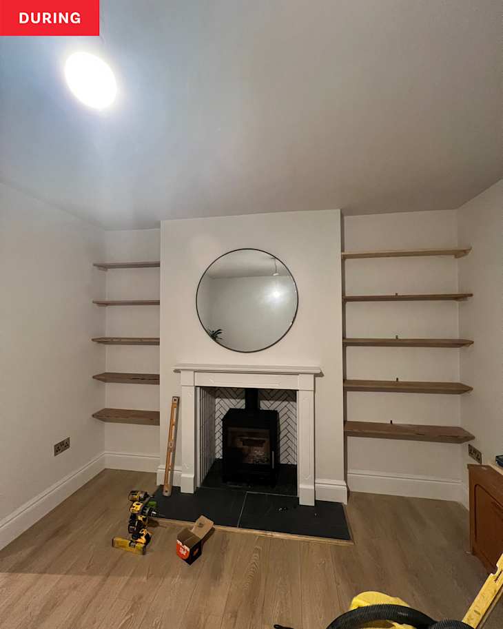 Living room with shelves and fireplace during renovation