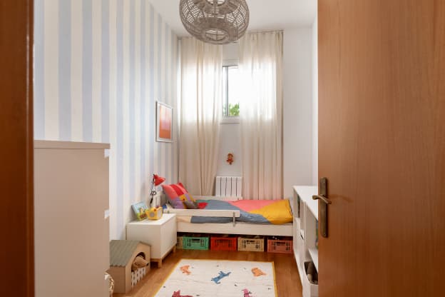 We Love the Blue Striped Walls and Colorful Storage Crates in This Barcelona Kid’s Room